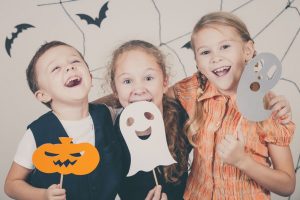 44636713 - happy brother and two sisters on halloween party