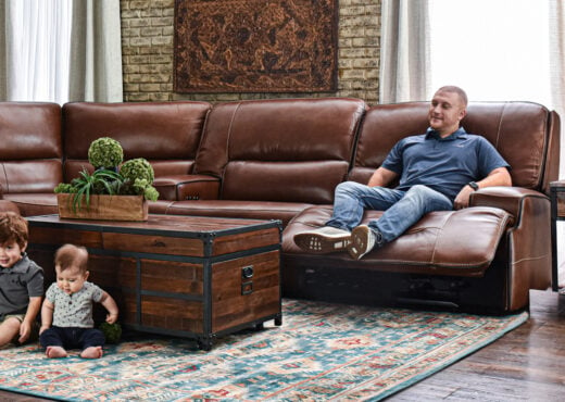 man sitting in brown sectional recliner